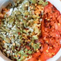 Naked Cali Bowl - Keto · Bowl of cottage cheese topped with avocado, tomato, pepitas, red pepper flakes, salt, pepper...