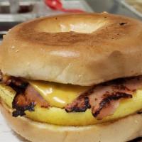 Bagel Sandwiches · Two eggs, cheddar cheese, and either ham, bacon or sausage, or steak. served on a toasted pl...