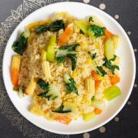 World Fried Rice · Stir fried Jasmine rice with broccoli, onions, peas, carrots, and egg, garnished with cucumb...