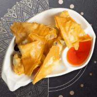 Crawling Crab Rangoon · Crab meat, cream cheese, green onion wrapped in crispy golden wontons, served with sweet Sri...