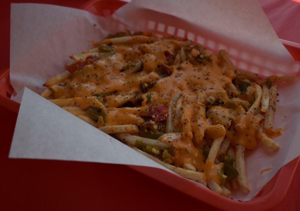 Green Chile Cheese Fries · Our Garlic Seasoned Fries topped with Roasted Green Chile and Cheddar Cheese Sauce.