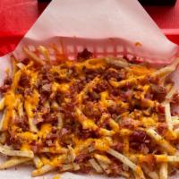 Bacon Cheddar Fries · A generous portion of our Garlic Fries Smothered in Cheddar Cheese Sauce and topped with Bac...