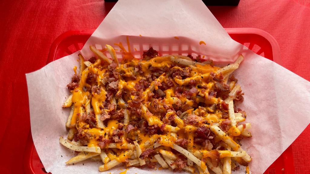 Bacon Cheddar Fries · A generous portion of our Garlic Fries Smothered in Cheddar Cheese Sauce and topped with Bacon.