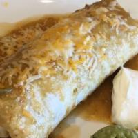 Veggie Burrito · Vegan. Rice, beans, guacamole, sour cream lettuce, cheese, smothered with green salsa. (see ...