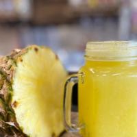 Agua De Piña · Pineapple drink sweetened with sugar.