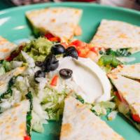 Quesadilla Appetizer · Two flour tortillas served with lettuce, guacamole, sour cream, tomatoes, onions, olives, an...