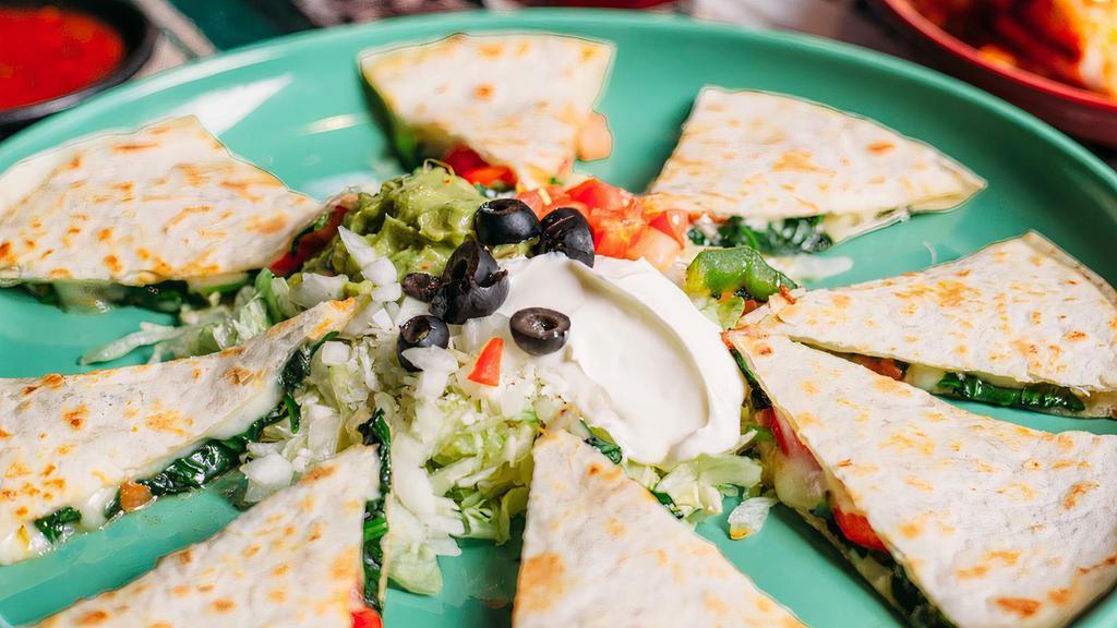 Quesadilla Appetizer · Two flour tortillas served with lettuce, guacamole, sour cream, tomatoes, onions, olives, and your choice of ground beef, shredded beef, shredded chicken, grilled chicken, steak or Jack cheese.