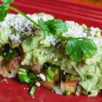 Guacamole Dip · Made with fresh avocado, cilantro, lime juice, tomatoes, and onions. Topped with spicy pico ...