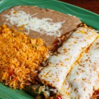 Veggie Enchiladas · Two filled corn tortillas covered in sauce and melted cheese, served with rice and beans. Fi...