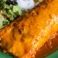 Deluxe Burrito · Flour tortilla filled with choice of meat, rice, and beans. Topped with red sauce, melted ch...