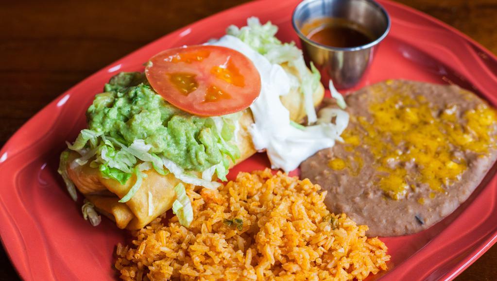 Chimichanga · Large flour tortilla filled with choice of meat, beans, and cheese, fried and topped with house red sauce, lettuce, tomatoes, and sour cream. Served with rice and beans. Choices:  veggie, ground beef, shredded beef, or shredded chicken.