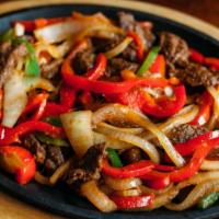 Fajitas · Choice of marinated meat sauteed with bell peppers and onions on a sizzling skillet. Served ...