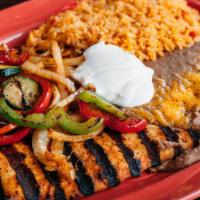 Pollo Asado · Marinated chicken breast cooked over charcoal. Topped with sauteed veggies and sour cream.