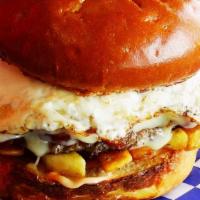 The Hangover · Beef Patty, Blue Moon Sauce, Sunny Side Up Fried Egg with French Fries on the burger on a Br...