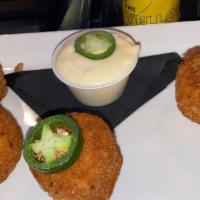 Fried Mac · Fried macaroni and cheese with jalapeño bits, cheese dip.