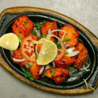 Chicken Tikka · Chicken breast marinated in herb spices, cheese and cream and broiled in clay oven.