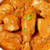 Chicken Korma · Chicken pieces cooked with Kashmiri herbs, cashews and raisins in a creamy onion sauce.