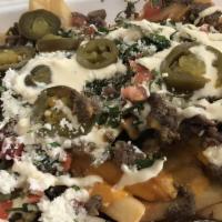 Asada Fries · Your choice of meat, fries, nacho cheese, pico de gallo, jalapenos, and sour cream.