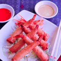 Thai Shrimp Rolls · Whole raw Jumbo Shrimps peeled with tail on, marinated overnight with special Thai herbs, th...