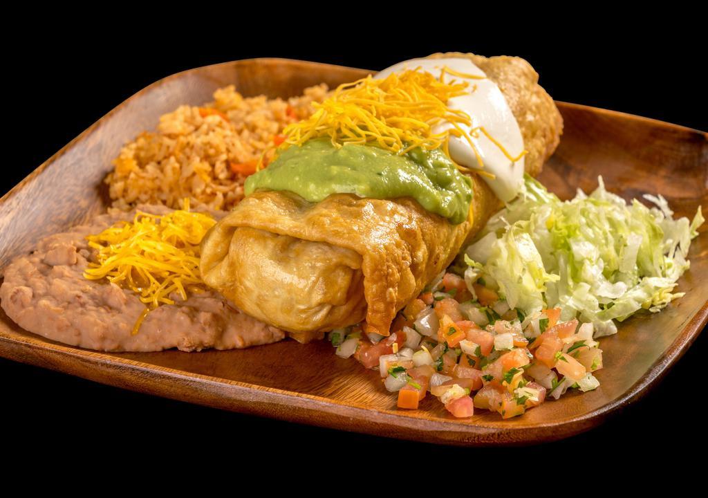 Chimichanga Plate · Shredded beef or chicken burrito, deep fried, and topped with guacamole, sour cream, cheese, pico de gallo, and lettuce.