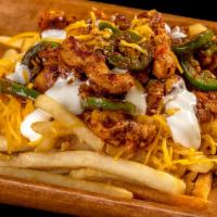 Cowboy Fries · French fries topped with grilled chicken in red sauce, jalapeños, cheese, and sour cream.
