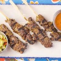 Hanger Steak Satay  · Tender slices of hanger steak, brushed with an aromatic coconut curry paste, skewered, and g...