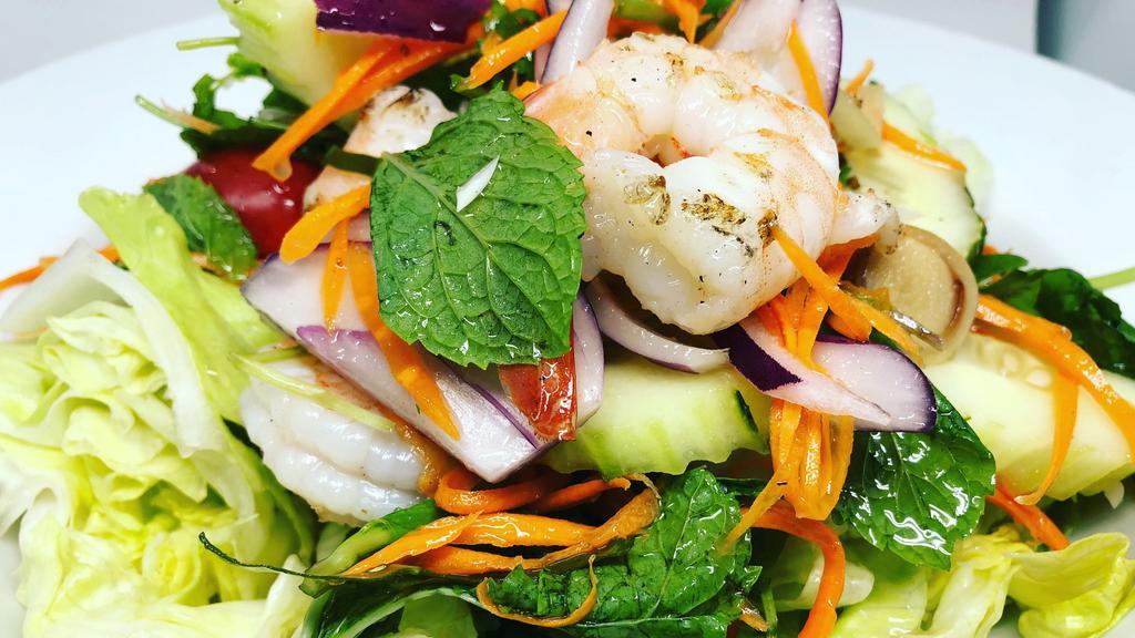 Bangkok Shrimp Salad  · Grilled prawns with lemon glass, cucumber, carrot shredded, tomatoes, green onion, red onion, cilantro, mint leaves, lettuce, with Thai dressing.