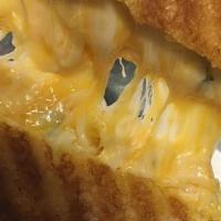 Grilled Cheese (Whole) · Our combination of Cheddar, jack and mozzarella cheeses, green onions and a touch of garlic....