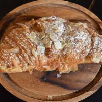 Almond  Croissant · A large flaky croissant with almond filling and topped with toasted almonds