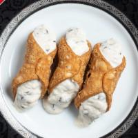 Cannoli · Lightly sweet ricotta with chocolate
chips fills three crisp pastry shells.