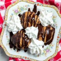Profittaroli · Cream puffs filled with whipped cream &
topped with a rich chocolate sauce.