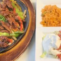 Steak Fajita  · A perfect tradition! tender pieces of your choice of marinated meat with grilled peppers, on...