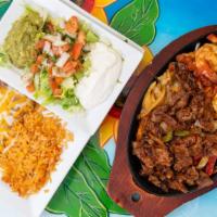 Fajita Combo · A perfect tradition! tender pieces of your choice of marinated meat with grilled peppers, on...