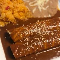 Chicken Enchiladas De Mole. · Topped with cheese and our famous mole sauce.
