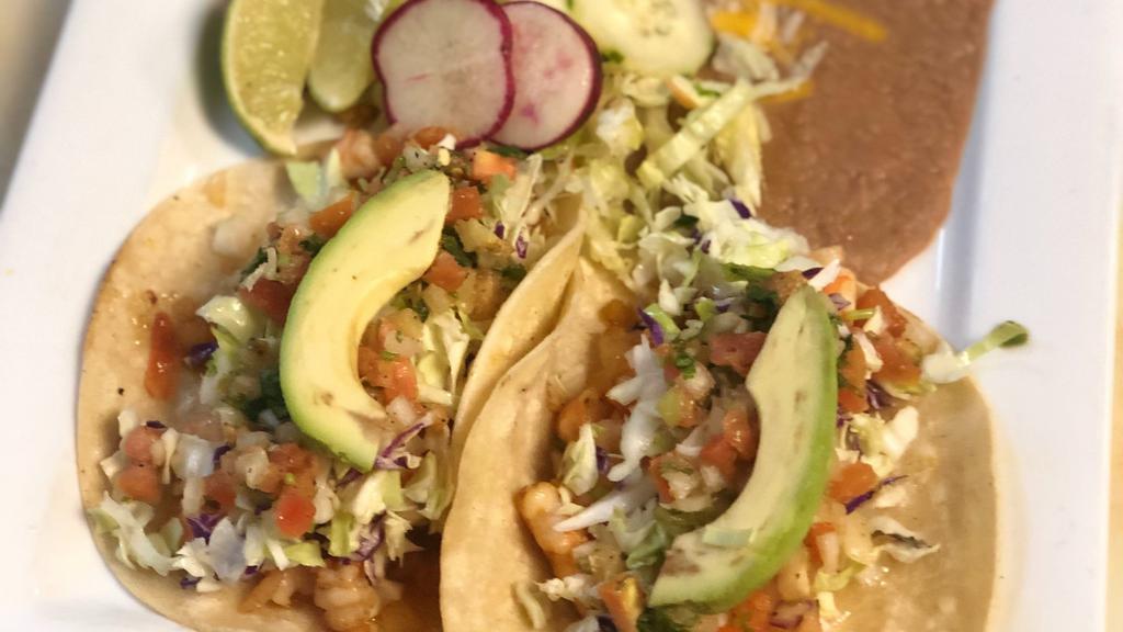 Tacos Mexico · Two corn or flour tortillas filled with your choice of meat, one avocado slice on each taco, cabbage and Pico de Gallo. Served with rice, beans and green tomatillo sauce. (Meat choice asada, pastor carnitas grilled chicken, fish, shrimp.)