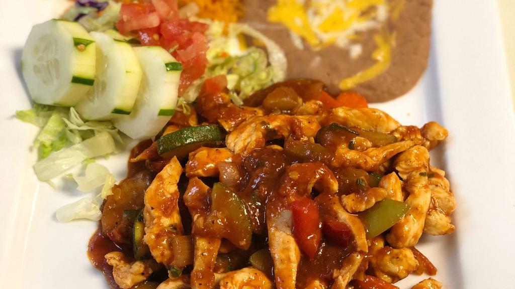 Chicken Mexican Style · Chicken breast slices specially prepared with onions, peppers, zucchini, and spices. Served with rice, beans, and warm tortillas.