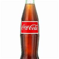 Bottle Of Coca-Cola® · A 12 oz. glass bottle of Coca-Cola®. A product of The Coca-Cola Company.