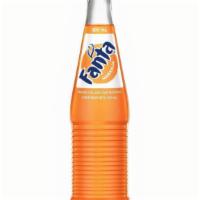 Bottle Of Fanta® · A 12 oz. glass bottle of Fanta® Orange. A product of The Coca-Cola Company.