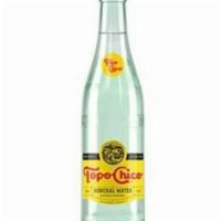 Bottle Of Topo Chico® · A 12 oz. glass bottle of Topo Chico® sparkling mineral water. A product of The Coca-Cola Com...