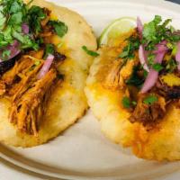 Cochinita Fluffy Tacos · Two handmade corn tortillas deep fried, roast pork, fried plantain, cilantro, pickled red on...