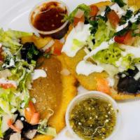 Bean Fluffy Tacos · Two handmade deep fried tortillas, black beans, cheese, lettuce, pico de gallo, sour cream a...