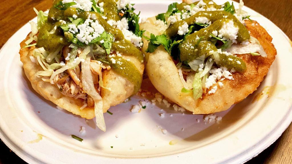 Veggie Fluffy Tacos · Two handmade tortillas deep fried, grilled mushrooms with hominy and bell peppers in mild tomatillo salsa, lettuce, cheese and cilantro.