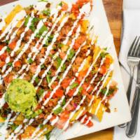 Loaded Nachos · Chips, refried beans, cheese, pico de gallo, sour cream and guac. 1040 Cal.