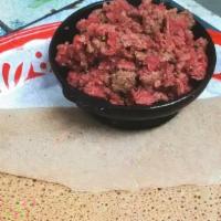 Kitfo · Very lean beef chopped and warmed in mitmieta spiced butter. Served with cottage cheese and ...