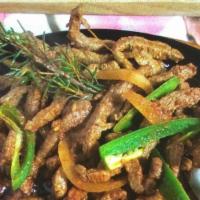 Zilzil Tib · Strips of tender charbroiled beef seasoned with garlic, black pepper, rosemary, and onions.