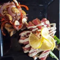 Ahi Sliders · Blackened ahi tuna paired with tomato and cucumber topped with lemon-caper aioli on three fr...