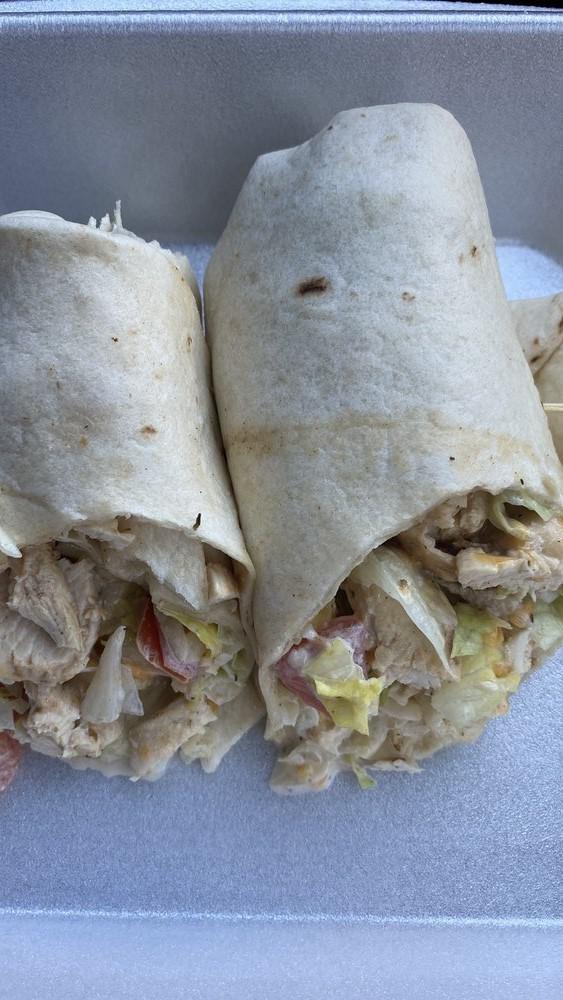 Chicken Bacon Ranch Wrap · Fresh grilled chicken tossed in lettuce, tomato, shredded jack, and cheddar cheese and housemade ranch, wrapped in a warm flour tortilla.