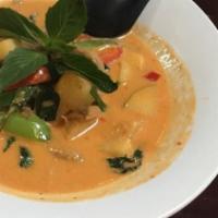 Roast Duck Curry · Red curry paste in coconut milk with sliced roast duck with pineapple, green apple, cherry t...