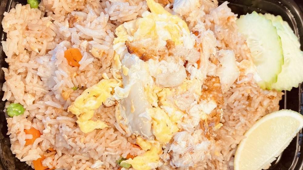 Crab Fried Rice · Stir fried jasmine rice with crab meat, egg, onions, carrots and peas.
