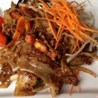 Drunken Noodles · Flat rice noodles stir fried with Thai chili, garlic, tomatoes, onions, bell peppers, and ba...